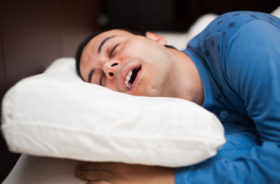 Man sleeping soundly in his bedroom, snoring