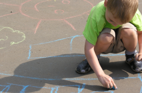 Boy drawing with chalk - Quick Care Med