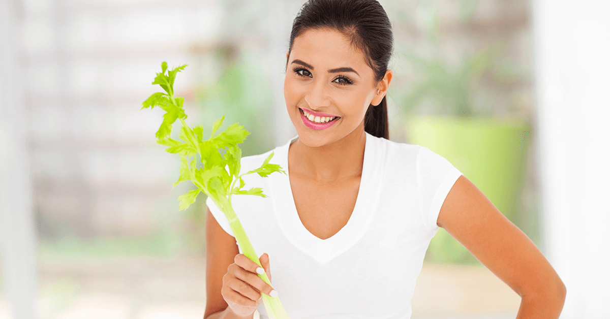 Woman eating celery as a healthy snack